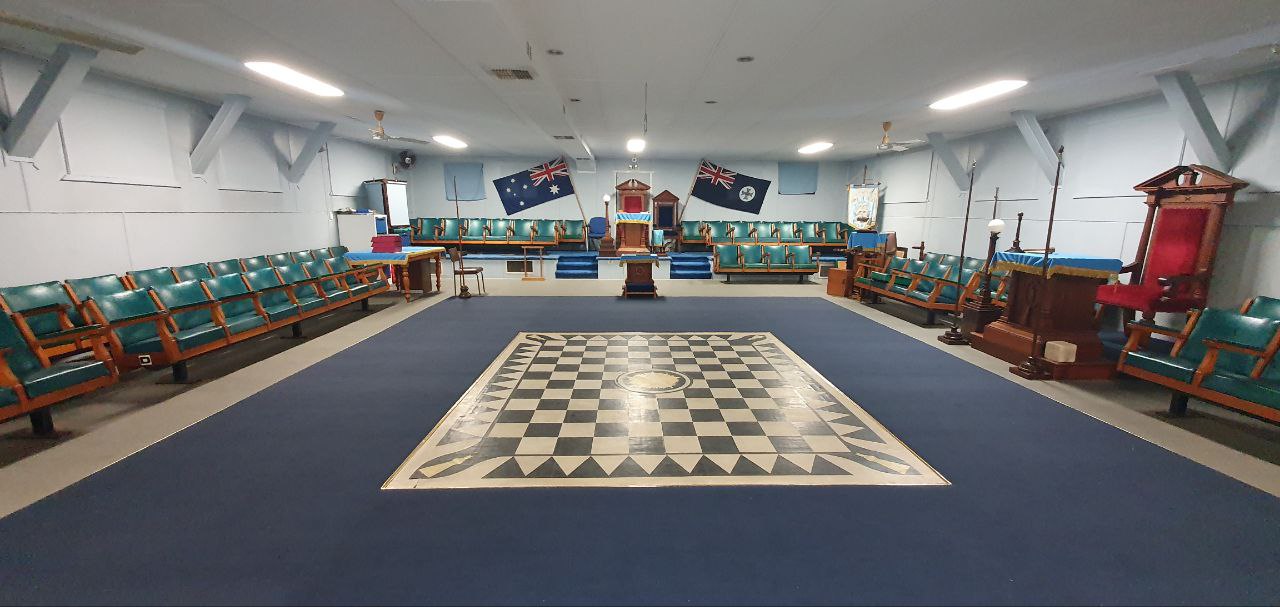 Interior of the lodge room with chequered floor, seating, and officers’ chairs